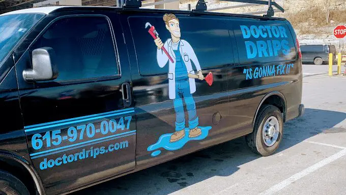 A van with a painting of a man holding a wrench.