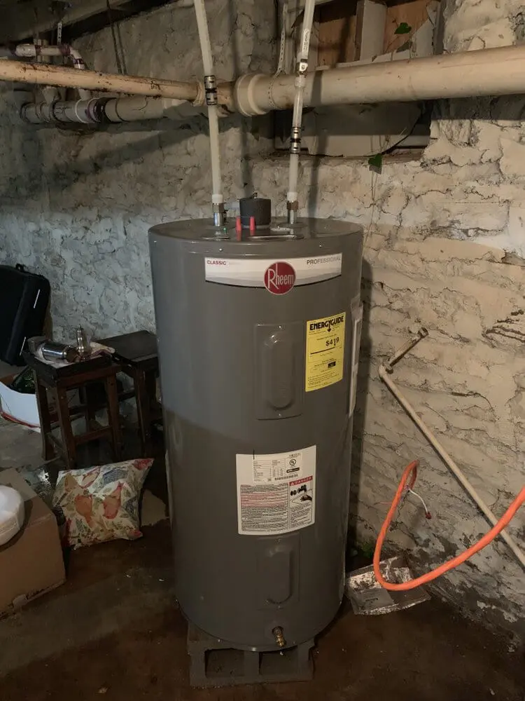 A water heater sitting in the middle of a room.