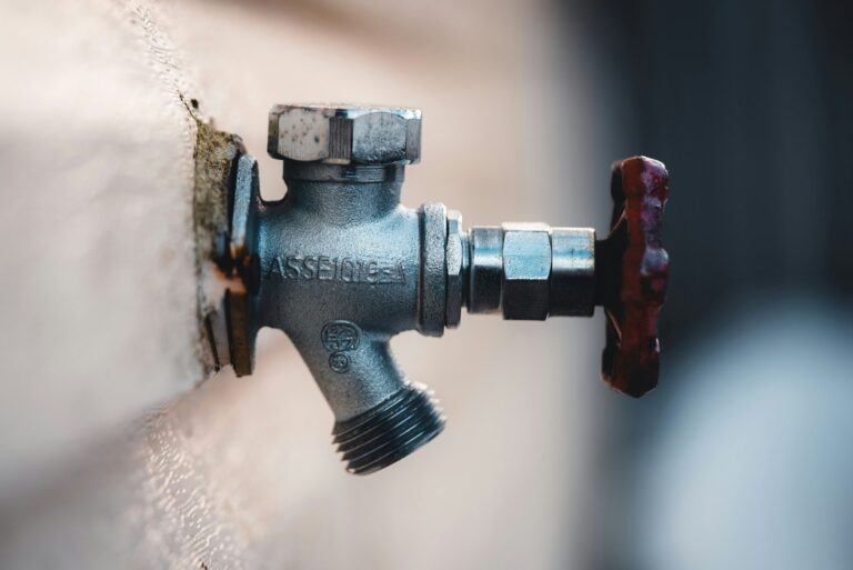 Outdoor hose spigot mounted on an exterior wall