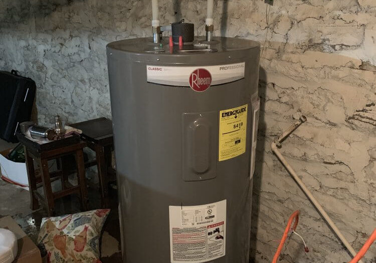 A water heater sitting in the middle of a room.